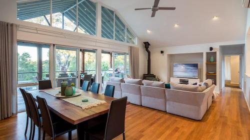 a living room with a table and a couch at Sky View - Elevated Estate with Resort-Style Pool in Yallingup