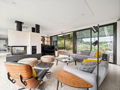 a living room filled with furniture and a fireplace at Sophie's Vineyard - Sprawling Scenery with Pool in Yallingup