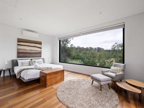 a bedroom with a bed and a large window at Sophie's Vineyard - Sprawling Scenery with Pool in Yallingup