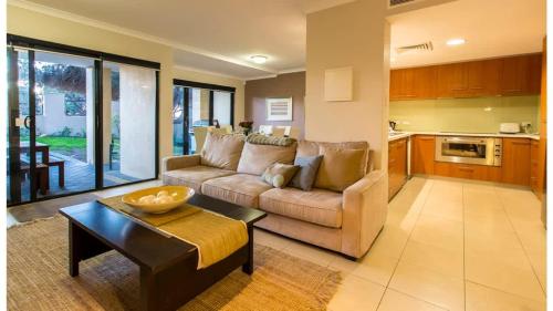 a living room with a couch and a table at Surfside 9 - In the Idyllic Yallingup Beach Scene in Yallingup