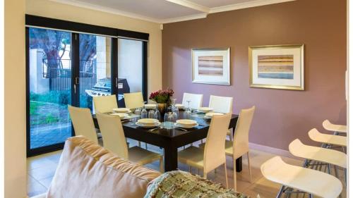 a dining room with a table and chairs at Surfside 9 - In the Idyllic Yallingup Beach Scene in Yallingup