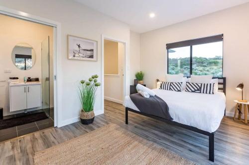 a bedroom with a large bed with a window at Rabbits Break - Beachside Bliss Steps from Yallingup in Yallingup