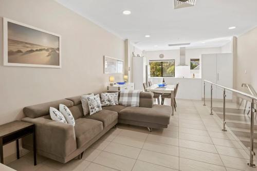 a living room with a couch and a table at Surfside 3A - Vibrant Yallingup Beachfront Living in Yallingup