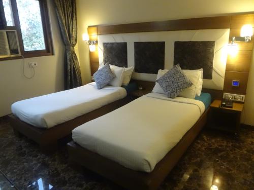 Posteľ alebo postele v izbe v ubytovaní Hotel Sapna