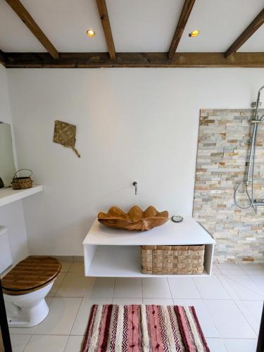 a bathroom with a toilet and a sink at Fare Tihi Moana in Tahu-Naoe