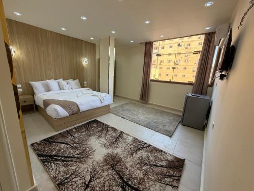 a bedroom with a bed and a television in it at Royal Pyramids Hotel in Cairo