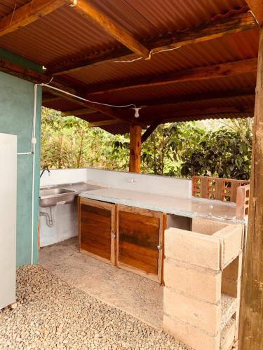a kitchen under a wooden roof with a counter top at Cabaa el Sol Medellin in Titiribí
