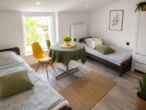 a living room with a table and a bed at Powidz Work & Stay in Powidz
