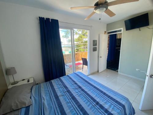 a bedroom with a bed and a ceiling fan at Blue Flamingo Kite Beach in Cabarete