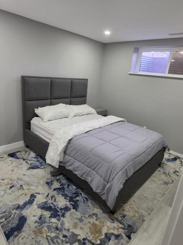 a bedroom with a large bed in a room at Cozy New 2BR Suite Retreat in Calgary