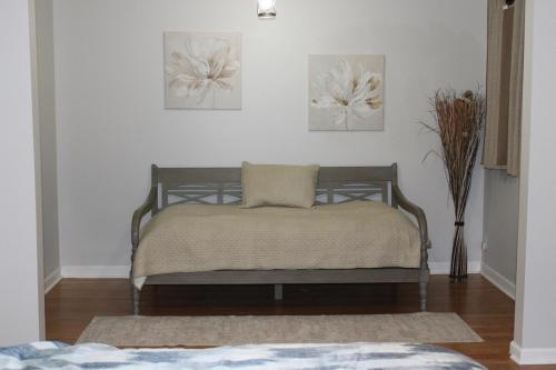 a bed in a room with two pictures on the wall at The Audobon Escape in Aiken