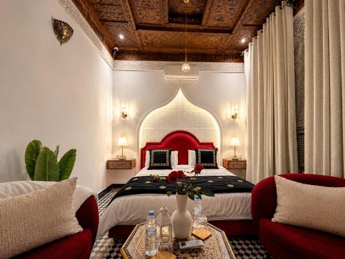 a bedroom with a large bed with a red headboard at Riad Fes Palais Bab Sahra Suites & Cooking Workshops in Fez