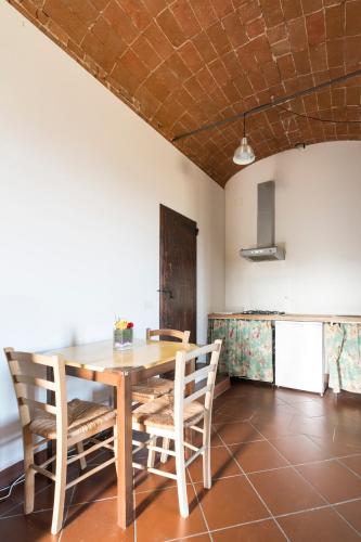 a dining room with a wooden table and chairs at Agriturismo Montevecchio Isolani in Monte San Pietro