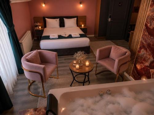 a hotel room with a bed and a bath tub at Asgard Hotel in Beylikduzu