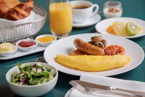 a table with plates of breakfast foods and drinks at Four Seasons Hotel Tokyo at Marunouchi in Tokyo
