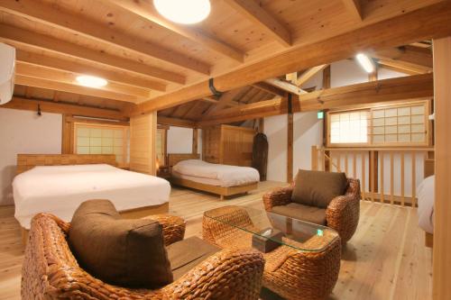 a bedroom with a bed and furniture in a room at 千年乃宿 in Kubo