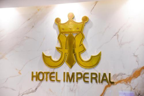 a sign for a hotel imperial with a crown at Hotel Imperial in Kuala Lumpur