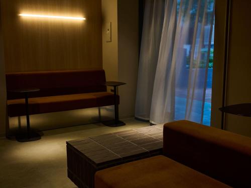 a waiting room with a bench and a window at SMART PLACE iNN Hakata-Gion in Fukuoka