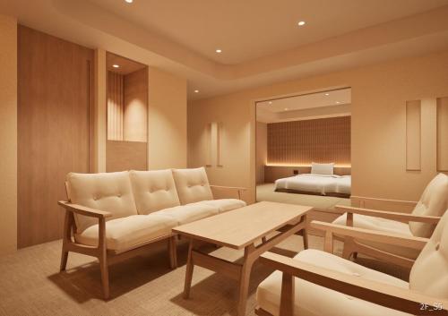 a living room with a couch and a bed at Shinzan Kinosaki in Toyooka