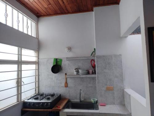 a small kitchen with a stove and a sink at Aparta Studio Las Palmas in La Dorada