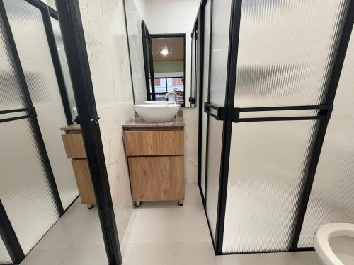 a bathroom with a sink and a mirror at Hotel del Parque Arauca in Arauca