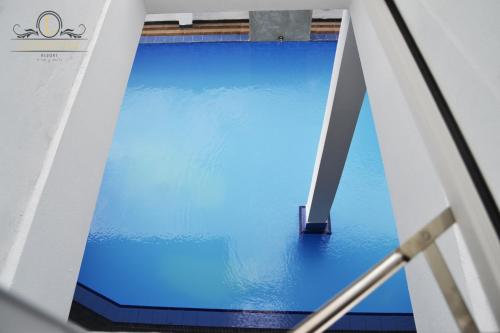 a view from a window of a pool of blue water at Leighton Resort in Negombo