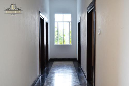 an empty hallway with a window in a building at Leighton Resort in Negombo