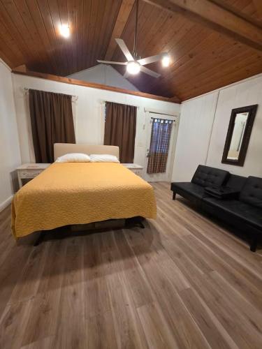 a large bedroom with a bed and a couch at River Run Maggie's house in Kerrville