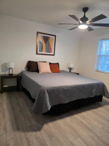a bedroom with a bed and a ceiling fan at River Run Retreat in Kerrville