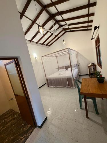 a room with a bed and a table in it at Sunny's Hide Out in Talalla South