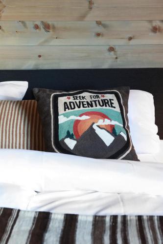 a pillow sitting on top of a bed at Solsiden Brygge Rorbuer in Ballstad