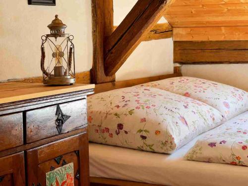 a bedroom with a bed with a lamp on it at Torwärterhaus Kipfenberg-Arnsberg in Arnsberg