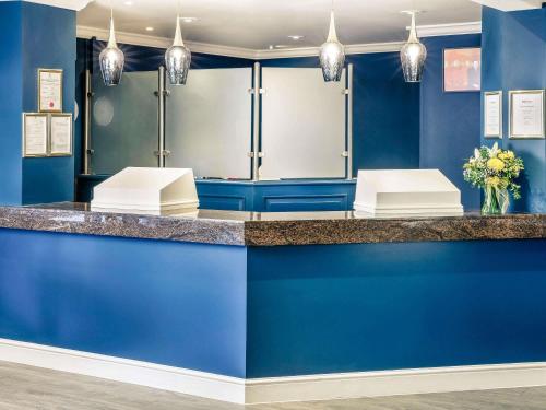 a dressing room with blue walls and a counter at Mercure Swansea Hotel in Swansea