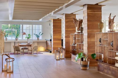 a room with a table and chairs and wooden walls at Meliá Cala Galdana in Cala Galdana