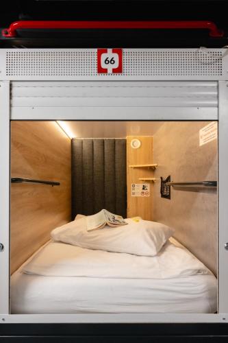 a view of a bed in a room at Kapsuła Hostel Warszawa in Warsaw