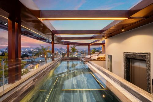 a swimming pool on the top of a building at XHOME Danang Hotel & Suite - Near My Khe Beach in Danang
