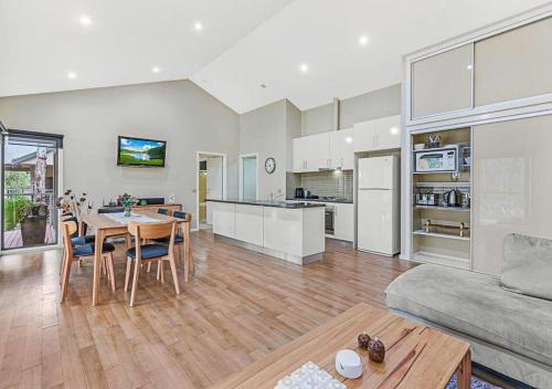 a kitchen and living room with a table and a couch at #4 Riverspa in Moama