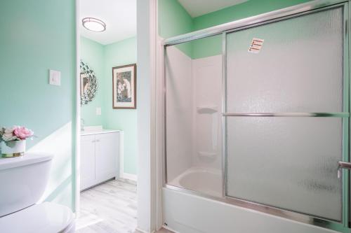 a bathroom with a shower with a glass door at Room B3 Shared bathroom queen bed privacy balcony in Rochester