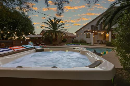 a jacuzzi tub in the backyard of a house at Sparkling SaltwtrPoolSpaFirepitFreeNetflixWiFi in Phoenix
