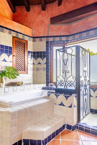 a large bathroom with a tub and a window at Rustic house with stunning lake view in Valle de Bravo