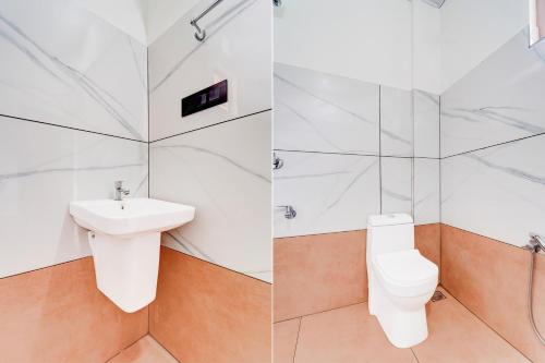 a bathroom with a toilet and a sink at Super Hotel O North Kalamassery in Cochin