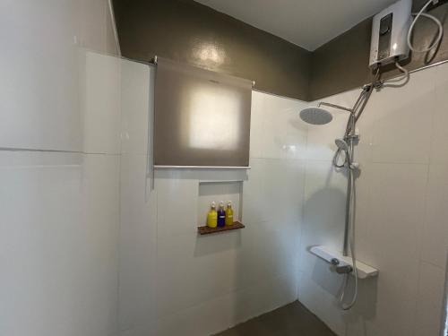 a bathroom with a shower with a sink and a toilet at Txaleta de Camiguin desde 2024 in Mambajao