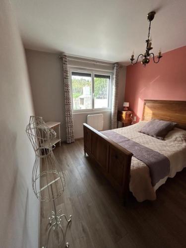 a bedroom with a large bed and a window at Le chaumet in SAINT DENIS EN MARGERIDE