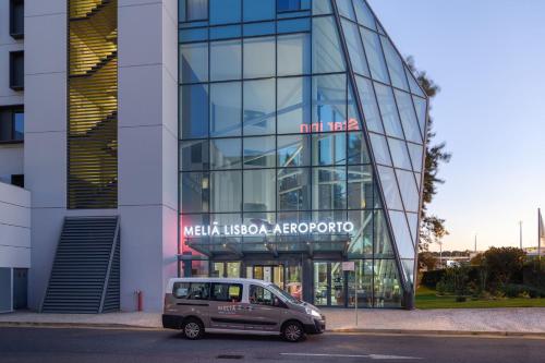 a car parked in front of a glass building at Meliá Lisboa Aeroporto in Lisbon