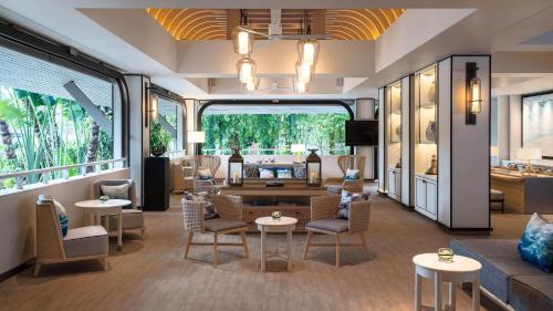 a lobby of a hotel with chairs and tables at Meliá Koh Samui in Choeng Mon Beach