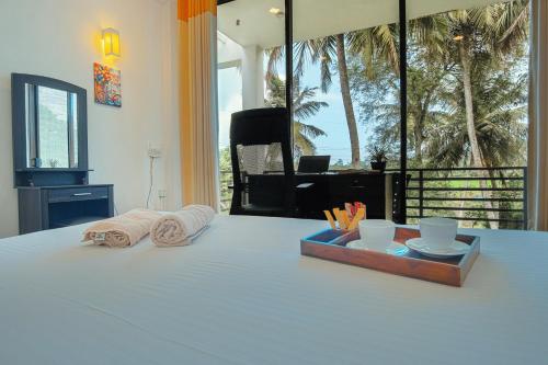 a bedroom with a bed with towels and a tray on it at Tranquil Heaven Near Galle & Unawatuna Quiet Stay & Fast WiFi in Galle