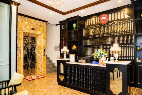 a bar in a restaurant with chairs and tables at Aurora Hotel SaPa in Sapa