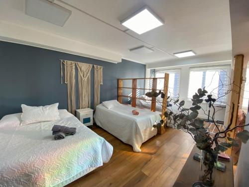 a bedroom with two beds and a window at El Martín Pescador in Osorno