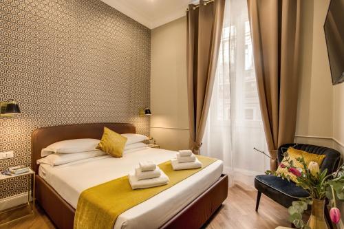 a hotel room with a bed and a chair at Charme Spagna Boutique Hotel in Rome