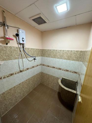 a bathroom with a shower and a toilet in a room at Kannan homestay in Kamunting